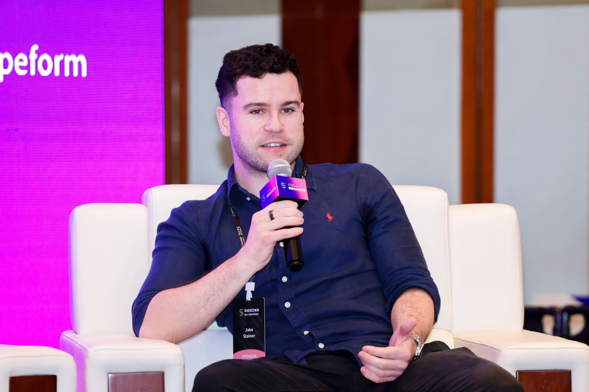 Jake Stainer, Room Raiders host, speaking into a microphone